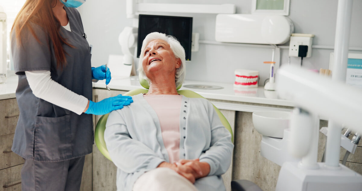 Dentist, consultation and senior woman in office, conversation and teeth whitening. People, doctor and patient with dental cleaning, discussion or inspection with cosmetic dentures or hygiene results.
